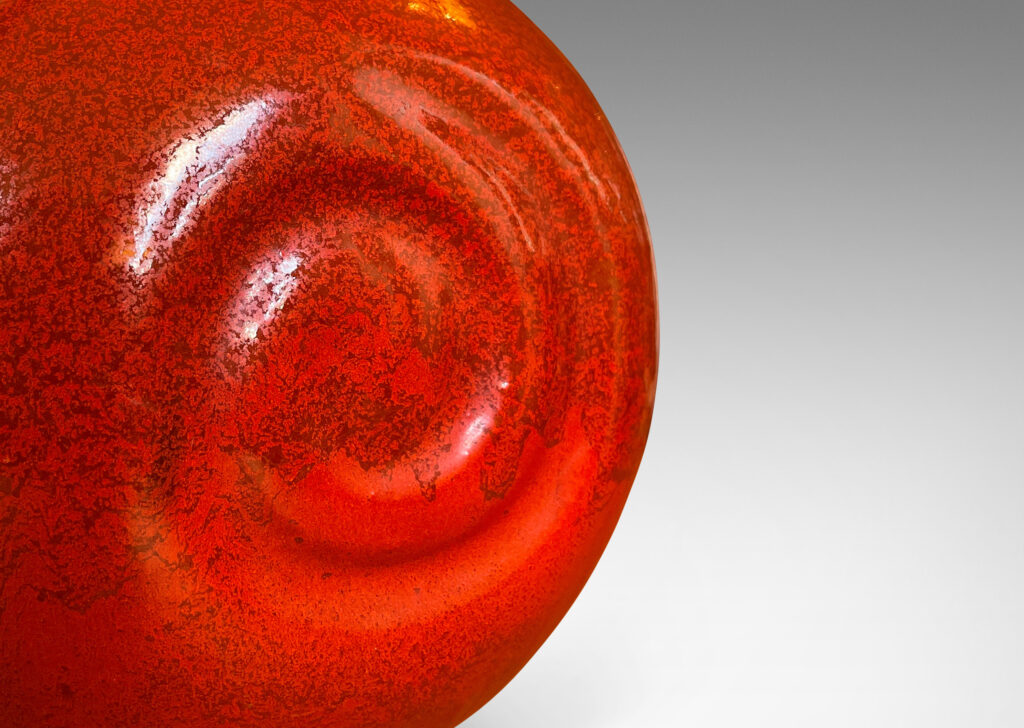 Gallery BAC globe form with relief spirals on two side in rich persimmon orange glaze