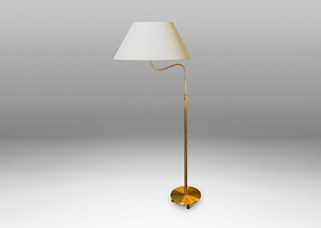 Gallery BAC stands with scroll arms (adjustable in height and direction) and a disk plinth; brass with wood feet and iron weight