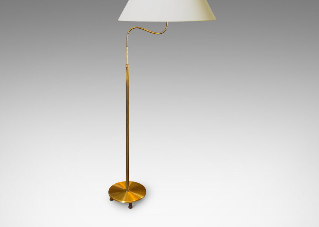 Gallery BAC stands with scroll arms (adjustable in height and direction) and a disk plinth; brass with wood feet and iron weight