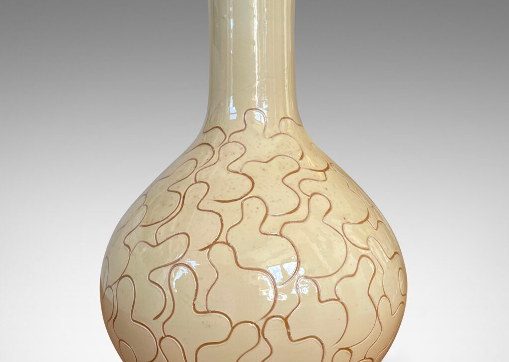 Gallery BAC decanter form with tall neck, glazed in a gloss ivory-cream and decorated with a sgraffito leaf pattern