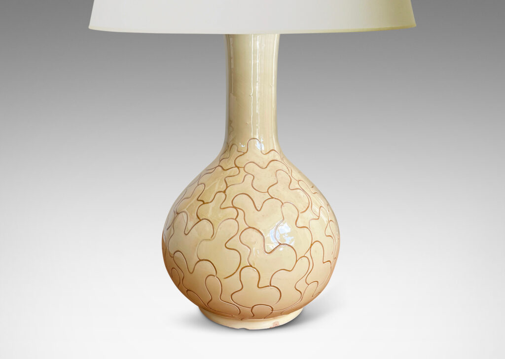 Gallery BAC decanter form with tall neck, glazed in a gloss ivory-cream and decorated with a sgraffito leaf pattern