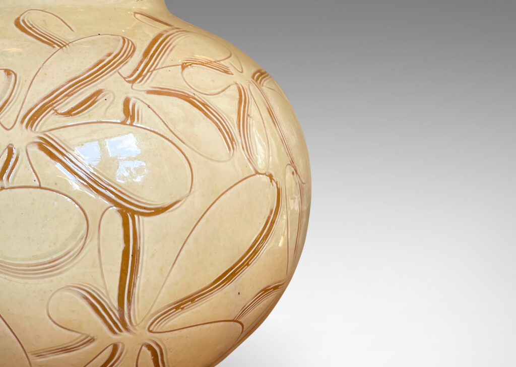 Gallery BAC globe form with wide neck, glazed in a gloss ivory and decorated with a sgraffito floral pattern