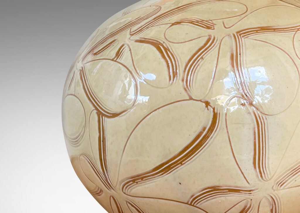 Gallery BAC globe form with wide neck, glazed in a gloss ivory and decorated with a sgraffito floral pattern