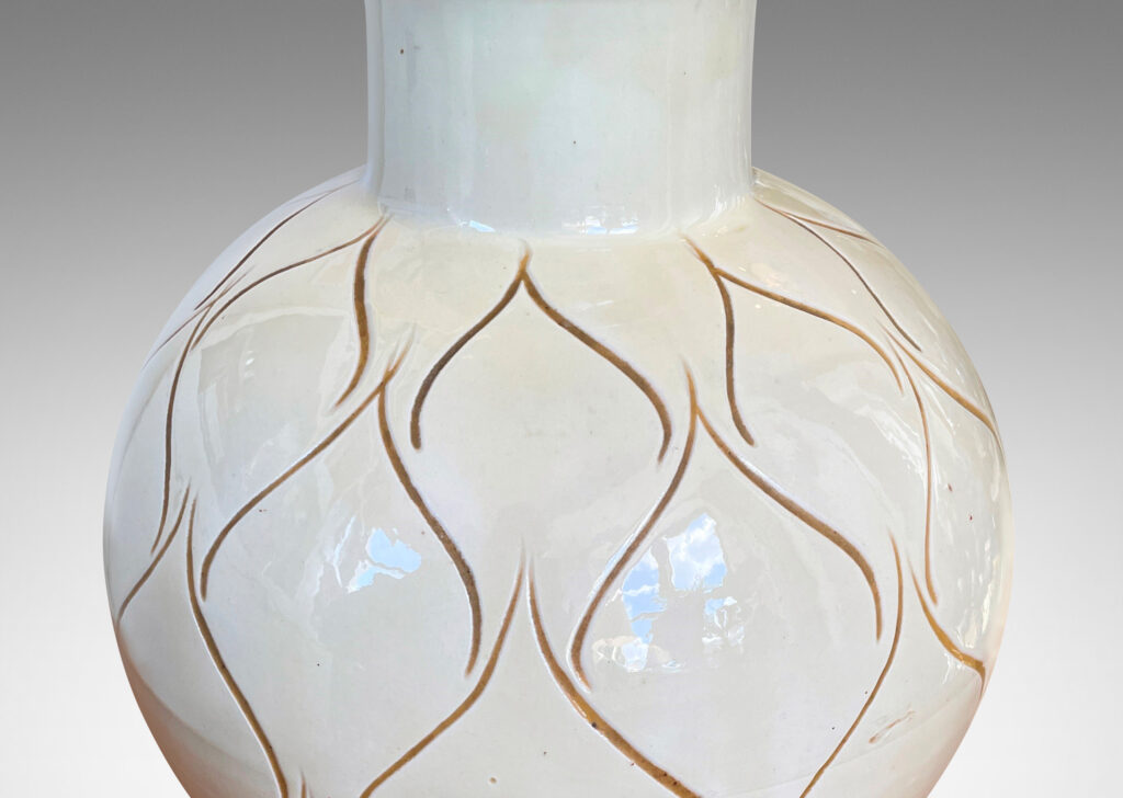 Gallery BAC globe form with wide neck glazed in a gloss ivory and decorated with a sgraffito ogival/leaf pattern