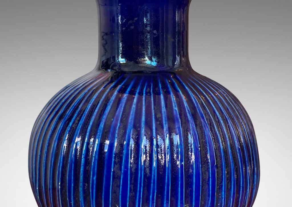 Gallery BAC plump pumpkin form with carved vertical ribs and wide neck, glazed in a gloss saturated deep blue