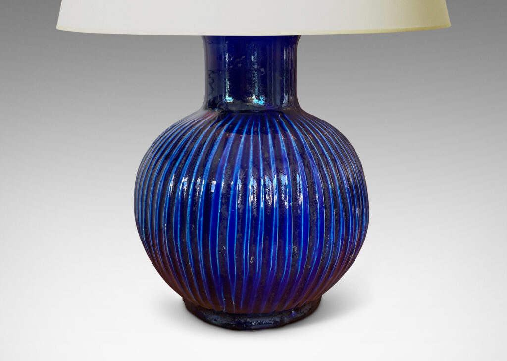 Gallery BAC plump pumpkin form with carved vertical ribs and wide neck, glazed in a gloss saturated deep blue