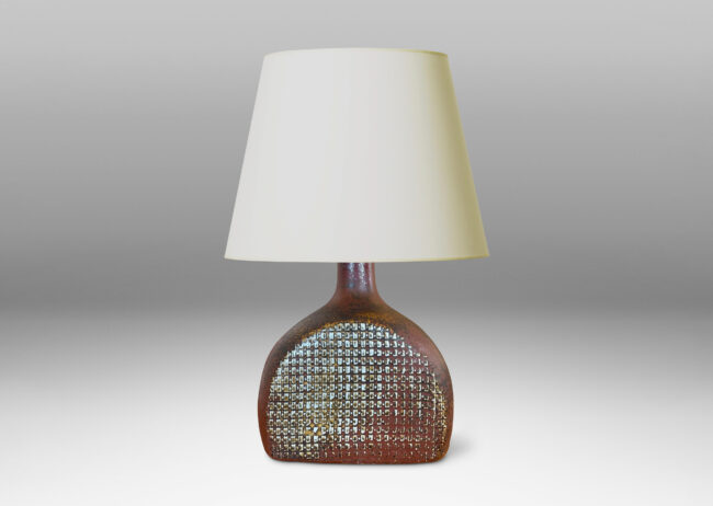 Gallery BAC bottle like form with a textured dome body and sprouting neck, glazed in a dappled oxblood