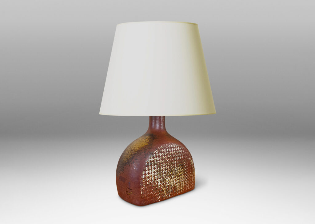 Gallery BAC bottle like form with a textured dome body and sprouting neck, glazed in a dappled oxblood