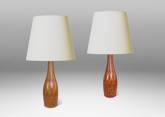 Gallery BAC tall bottle forms with carved diamond pattern, and glazed in terra-cotta/tan