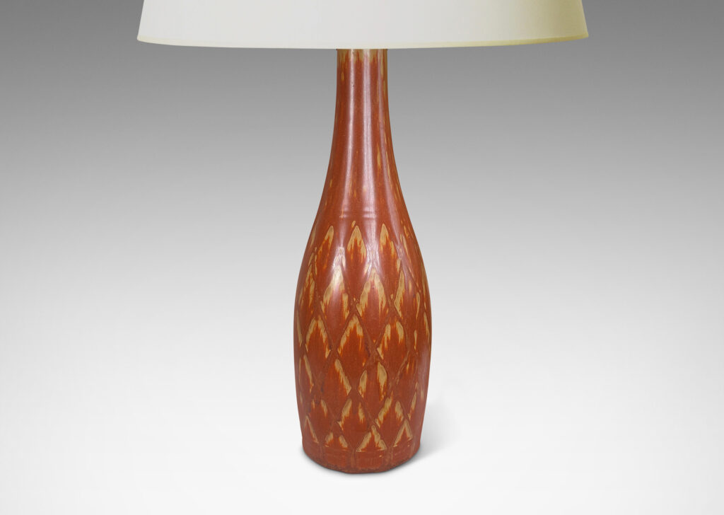 Gallery BAC tall bottle forms with carved diamond pattern, and glazed in terra-cotta/tan