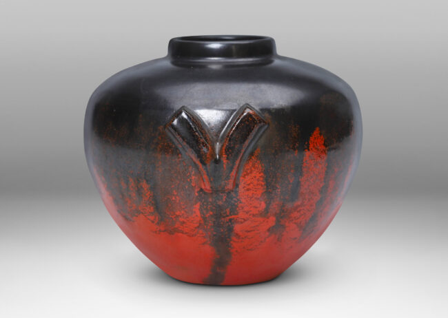 Gallery BAC tapered form with V-shaped handles, glazed in orange and dark gray luster