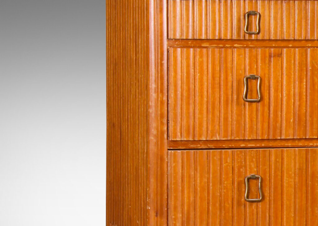 Gallery BAC three drawers with relief vertical ridges covering sides and legs, and organically modeled pulls; mahogany and brass