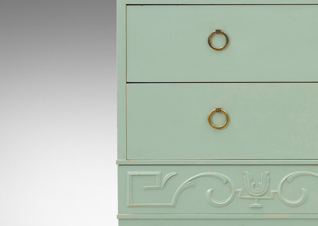 Gallery BAC three drawers, the lowest with relief classical motifs, the two above with ring pulls; birch and brass