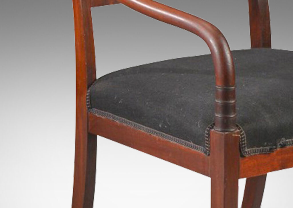 Gallery BAC sinuously modeled arms with carved ring details, large back rail with figured grain, and sabered legs; mahogany