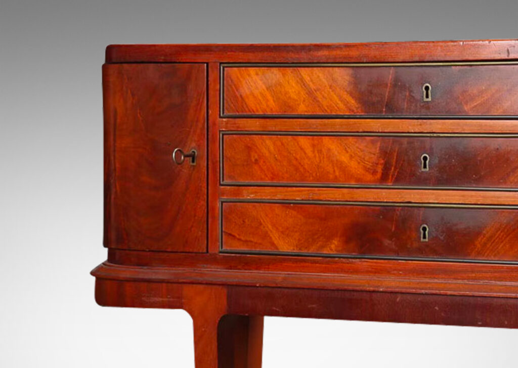 Gallery BAC hree drawers and rounded corner cabinets, on an articulated base with tapered legs; mahogany,