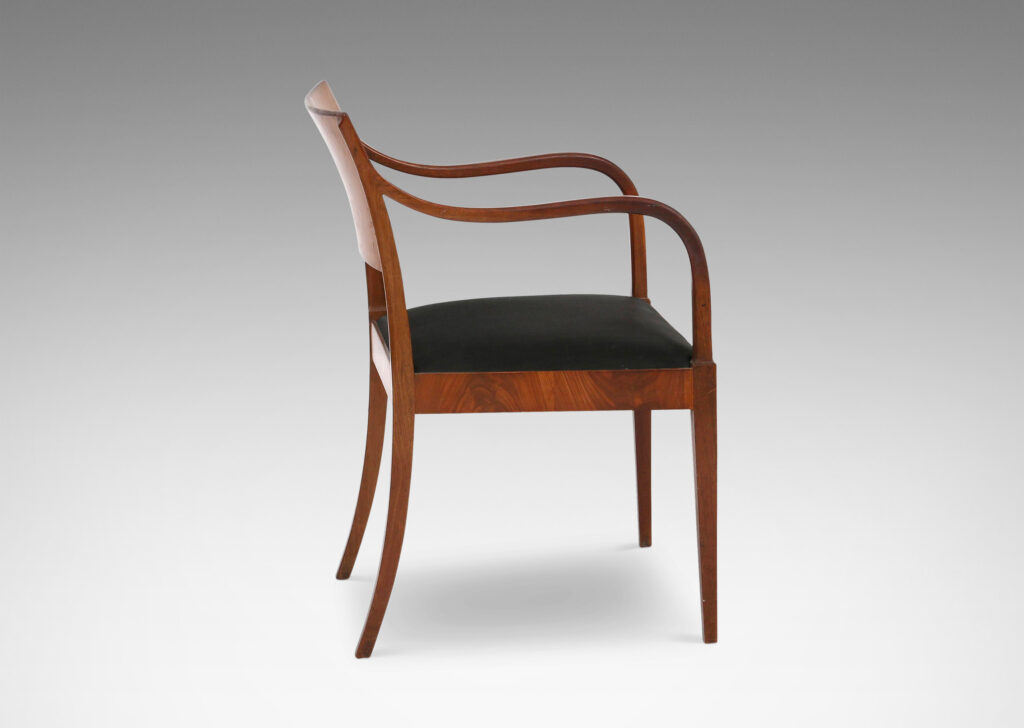 Gallery BAC klismos-style back, rolling arms and tapered legs; mahogany