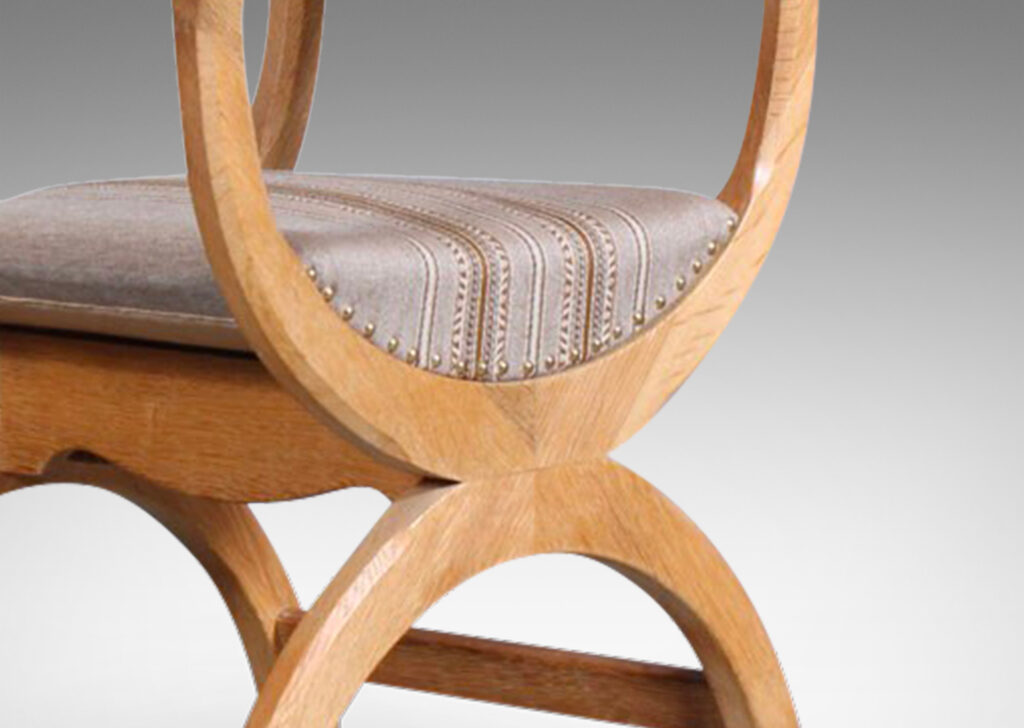 Gallery BAC “curule” style semi-circle seat and base, with sculpted arms and upholstered back rail; oak;