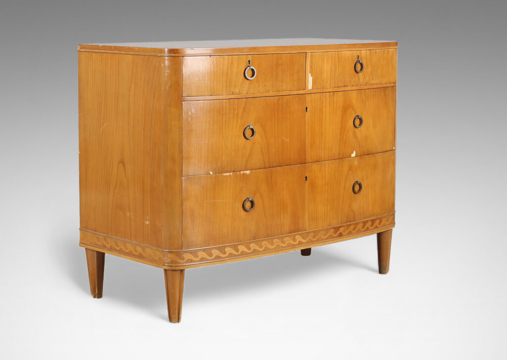 Gallery BAC four drawers, with tapered feet, ring pulls, and an ornamental inlaid band with a wave design