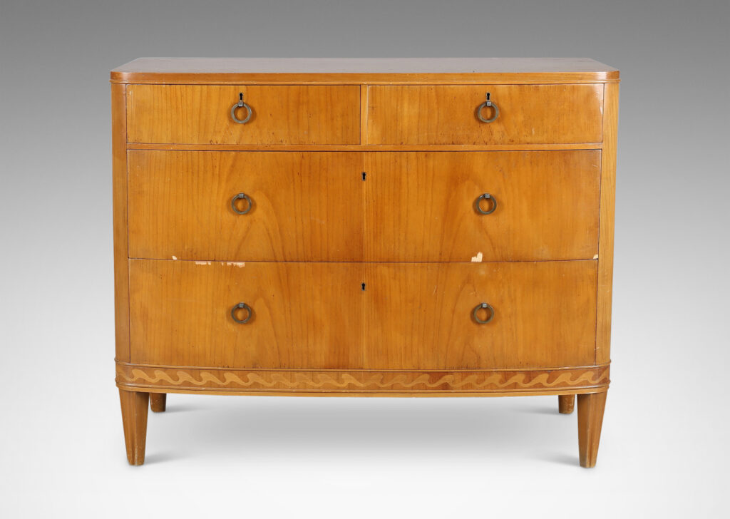 Gallery BAC four drawers, with tapered feet, ring pulls, and an ornamental inlaid band with a wave design