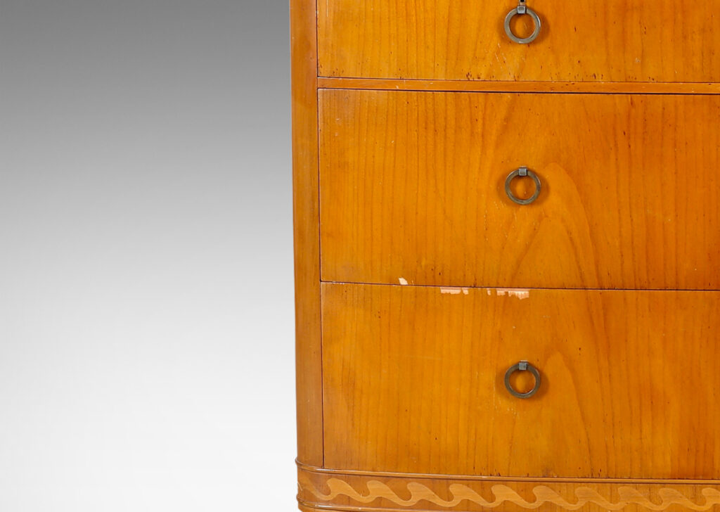 Gallery BAC four drawers, with tapered feet, ring pulls, and an ornamental inlaid band with a wave design