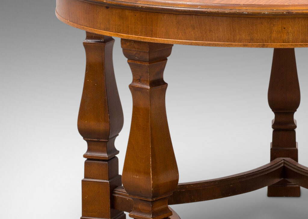 Gallery BAC round top with sunburst grain, perched on five sturdy square baluster legs linked by coved stretchers