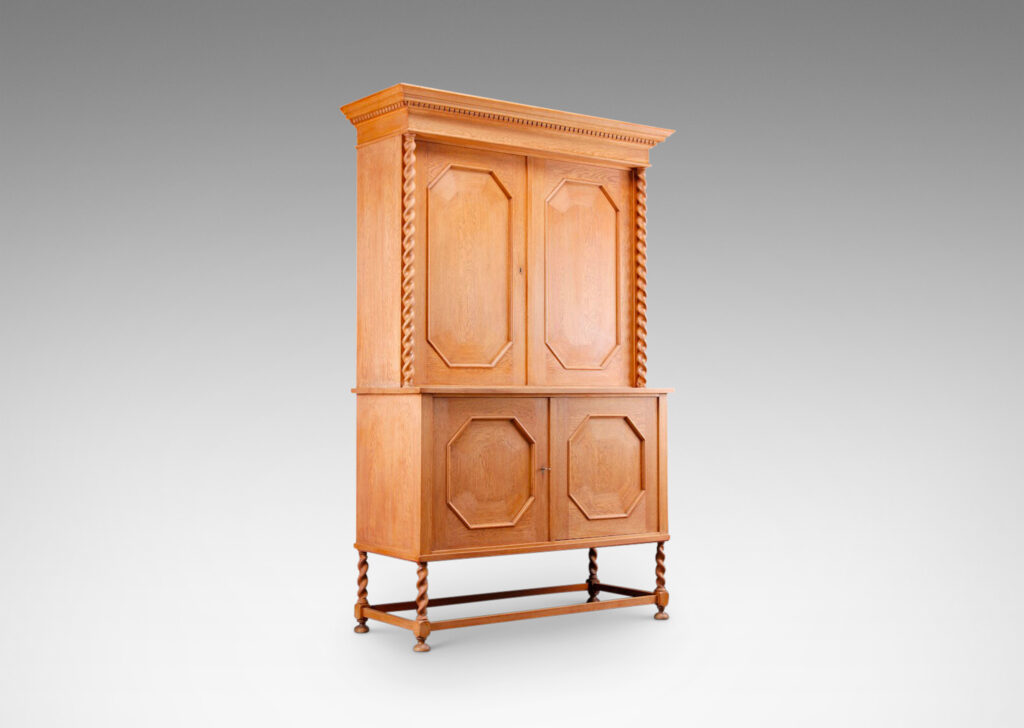 Gallery BAC cabinet having four doors with octagonal panels and mitered cornice with dentil detail