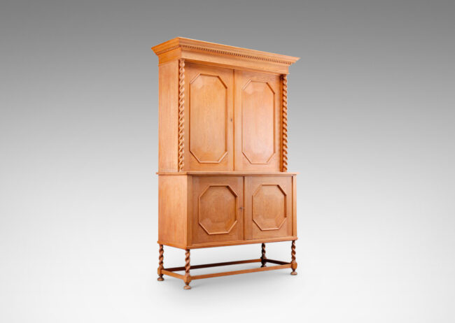 Gallery BAC cabinet having four doors with octagonal panels and mitered cornice with dentil detail