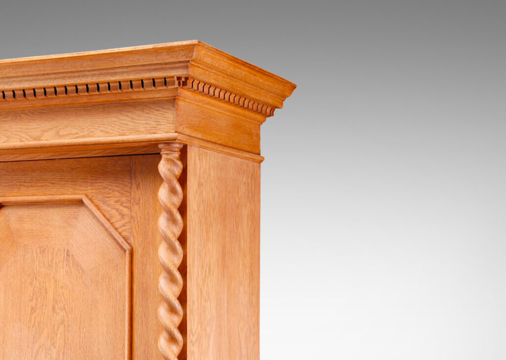 Gallery BAC cabinet having four doors with octagonal panels and mitered cornice with dentil detail