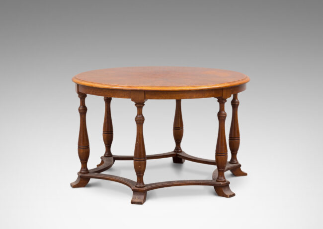 Gallery BAC muscular round top on six baluster legs connected with coved stretchers; walnut