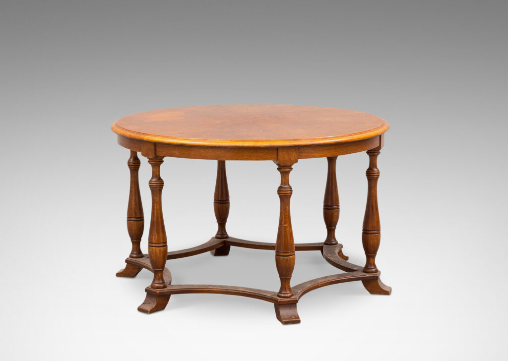 Gallery BAC muscular round top on six baluster legs connected with coved stretchers; walnut