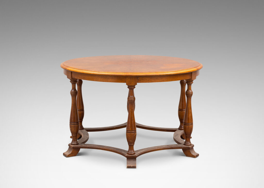 Gallery BAC muscular round top on six baluster legs connected with coved stretchers; walnut