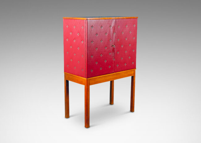 Gallery BAC two-door cupboard with shelves and three small drawers inside, covered in red leather tufted with diamond-form clusters of nail heads