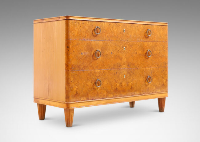 Gallery BAC three drawers veneered in burl with ring pulls, profiled top and bottom frame, and tapered legs; elm, burl and brass