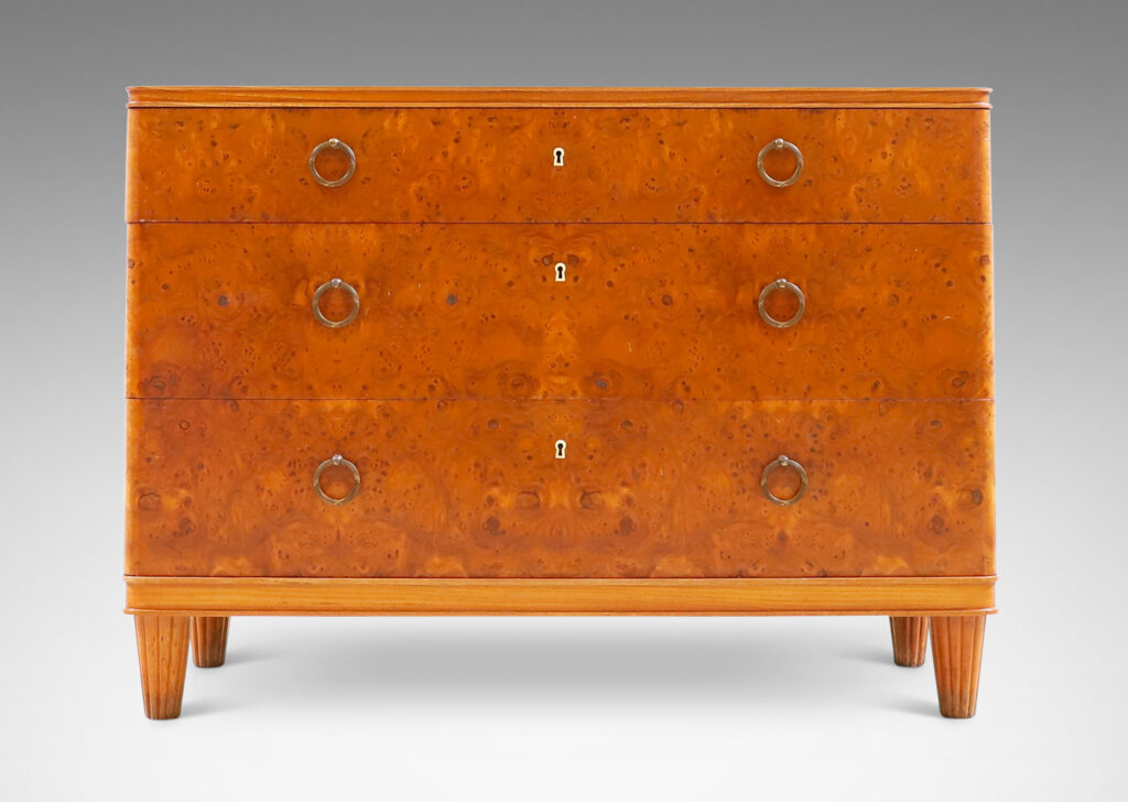 Gallery BAC three drawers veneered in burl with ring pulls, profiled top and bottom frame, and tapered legs; elm, burl and brass