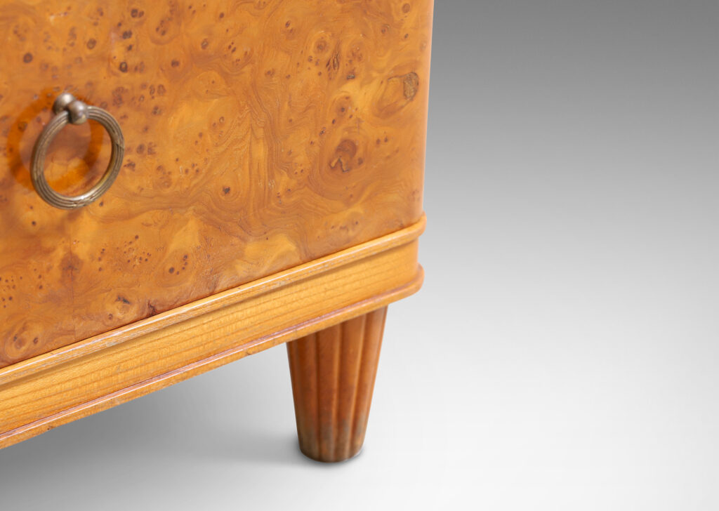 Gallery BAC three drawers veneered in burl with ring pulls, profiled top and bottom frame, and tapered legs; elm, burl and brass