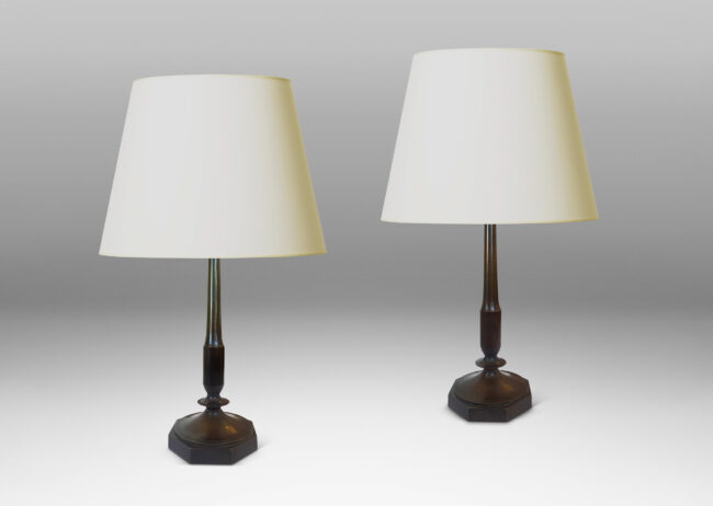 Gallery BAC profiled stands with stylized floral fobs on octagonal bases; patinated bronze