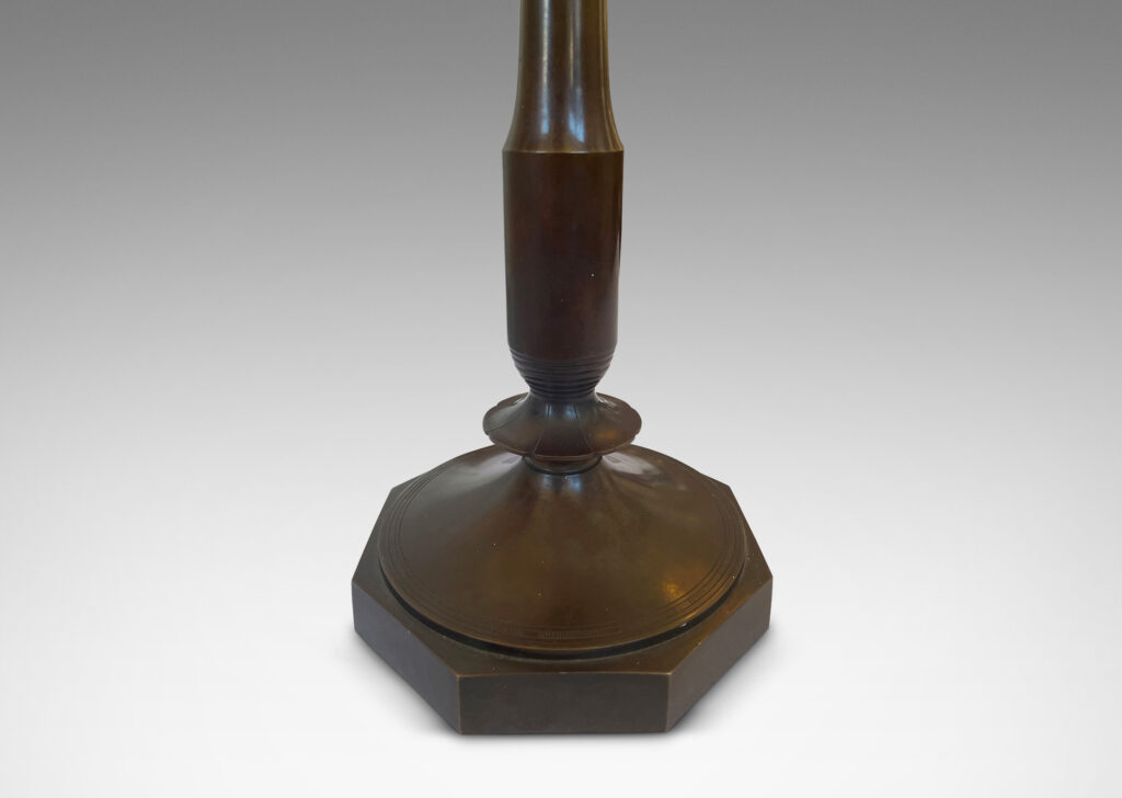 Gallery BAC profiled stands with stylized floral fobs on octagonal bases; patinated bronze