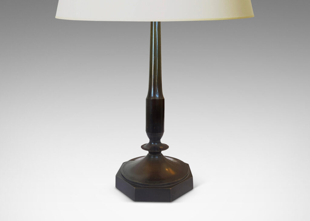Gallery BAC profiled stands with stylized floral fobs on octagonal bases; patinated bronze