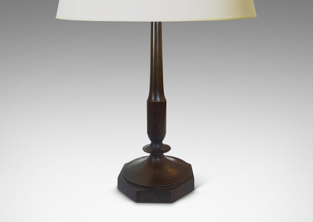 Gallery BAC profiled stands with stylized floral fobs on octagonal bases; patinated bronze