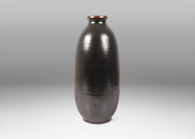 Gallery BAC tall ovoid form and flared lip, glazed in a dark brown orange-peel finish salt glaze