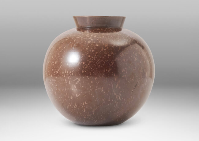 Gallery BAC plump globe form with flanged mouth, glazed in deep brown stippled with lighter brown