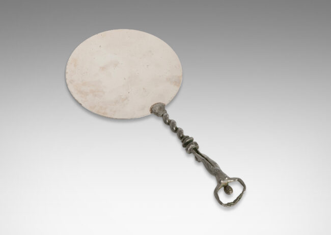 Gallery BAC polished disk with handle in the form of a barley twist with a female figure; pewter and white metal;