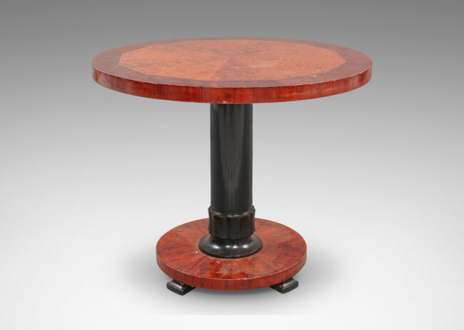 Gallery BAC floating round top and disk base, with ebonized carved pedestal and feet; birch with mahogany veneers