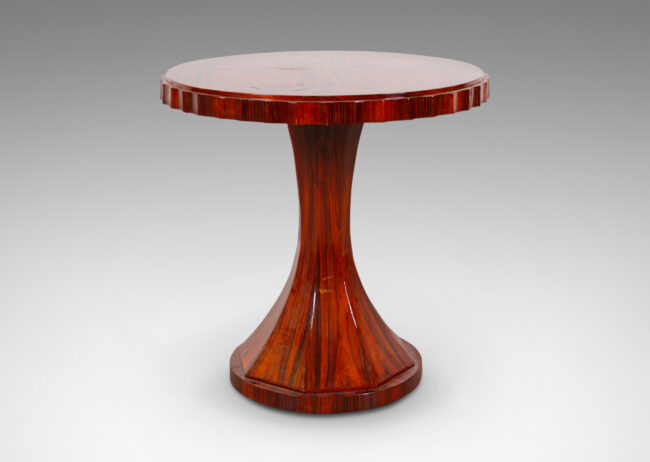 Gallery BAC round top in book-matched veneers and encircled in a fluted edge, with a cove-sided octagonal pedestal on a round base