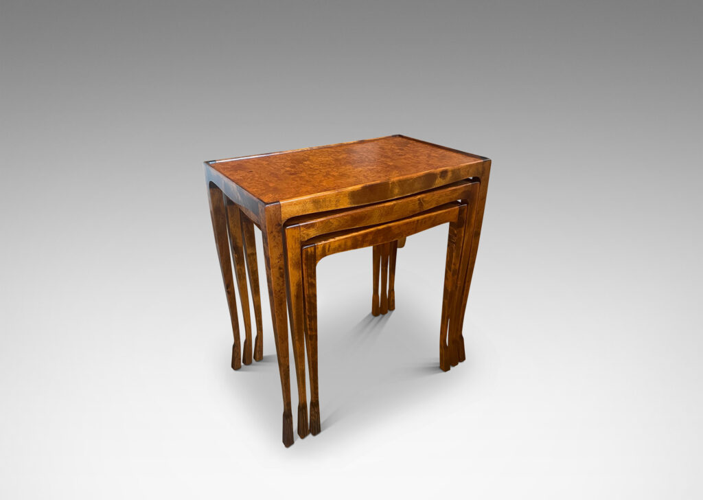 Gallery BAC slim rectangular tops with sinuously modeled legs ending in stylized lion paw feet; birch with burl veneer tops