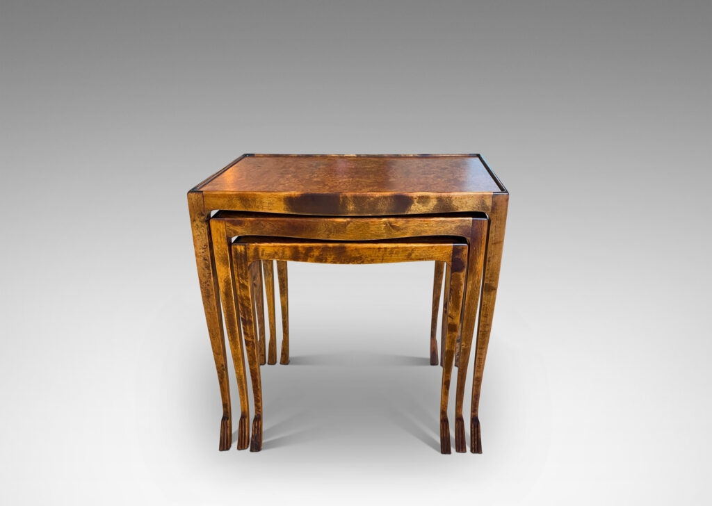 Gallery BAC slim rectangular tops with sinuously modeled legs ending in stylized lion paw feet; birch with burl veneer tops