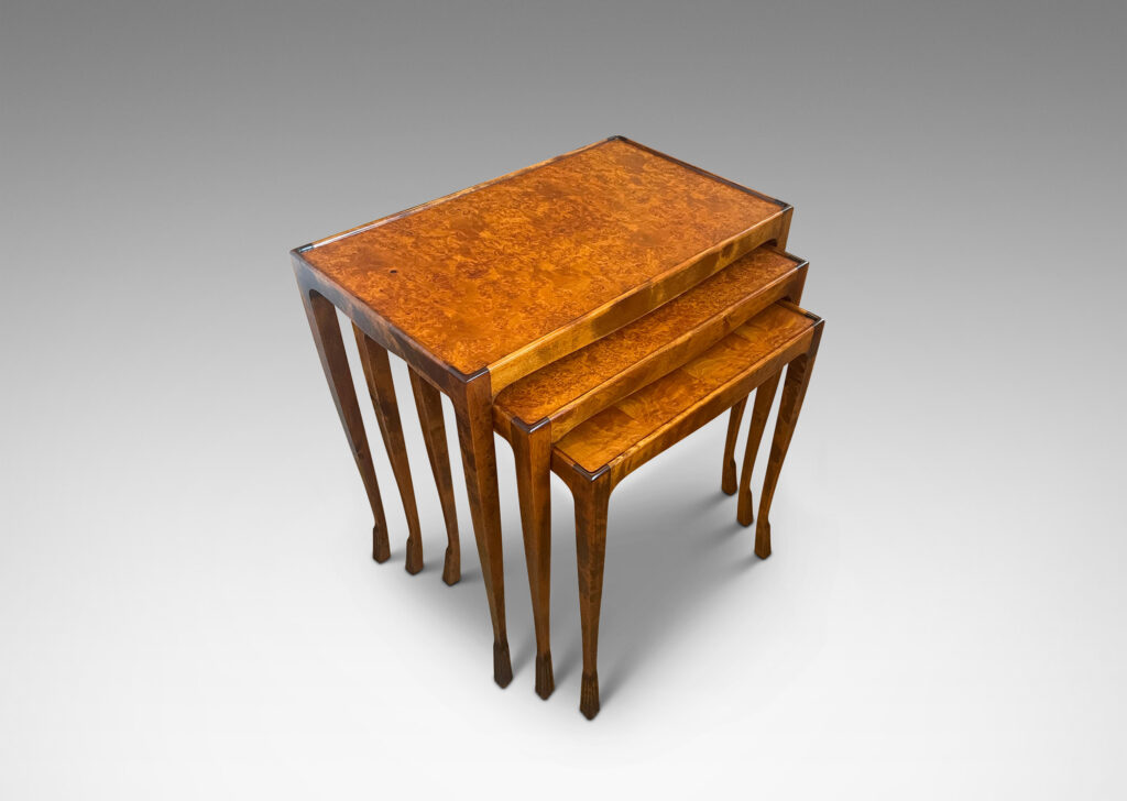 Gallery BAC slim rectangular tops with sinuously modeled legs ending in stylized lion paw feet; birch with burl veneer tops