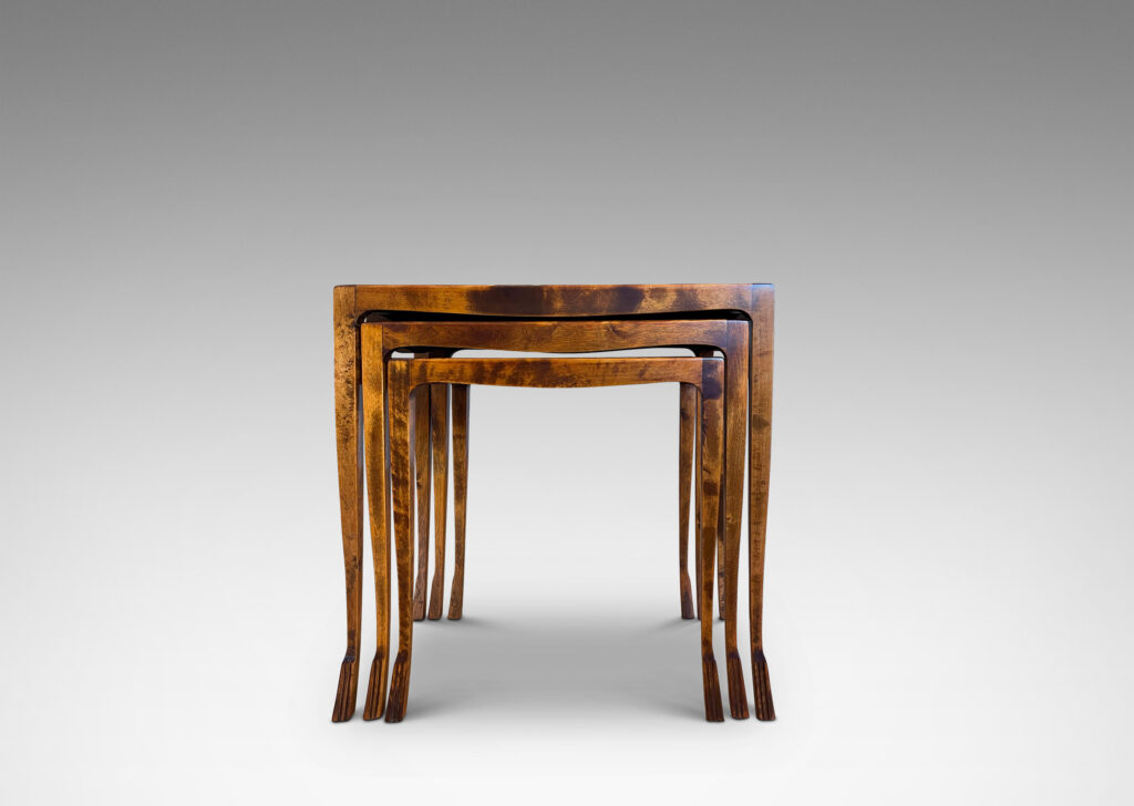 Gallery BAC slim rectangular tops with sinuously modeled legs ending in stylized lion paw feet; birch with burl veneer tops