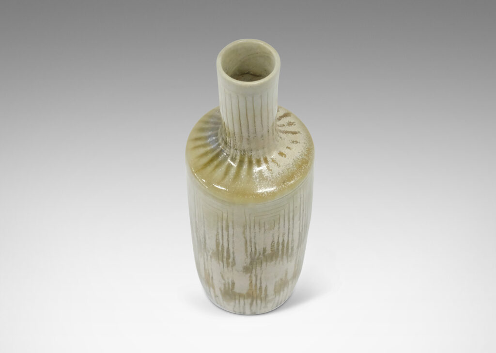 Gallery BAC tall rationalized bottle form, with carved concentric box design and a pale gray-olive green glaze