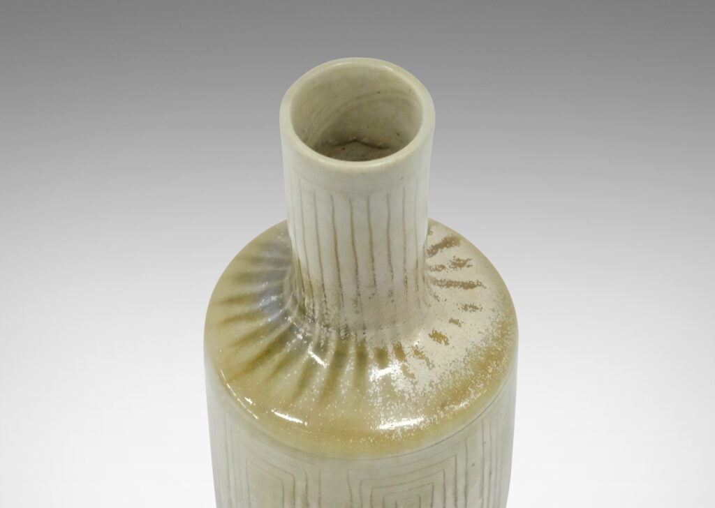 Gallery BAC tall rationalized bottle form, with carved concentric box design and a pale gray-olive green glaze